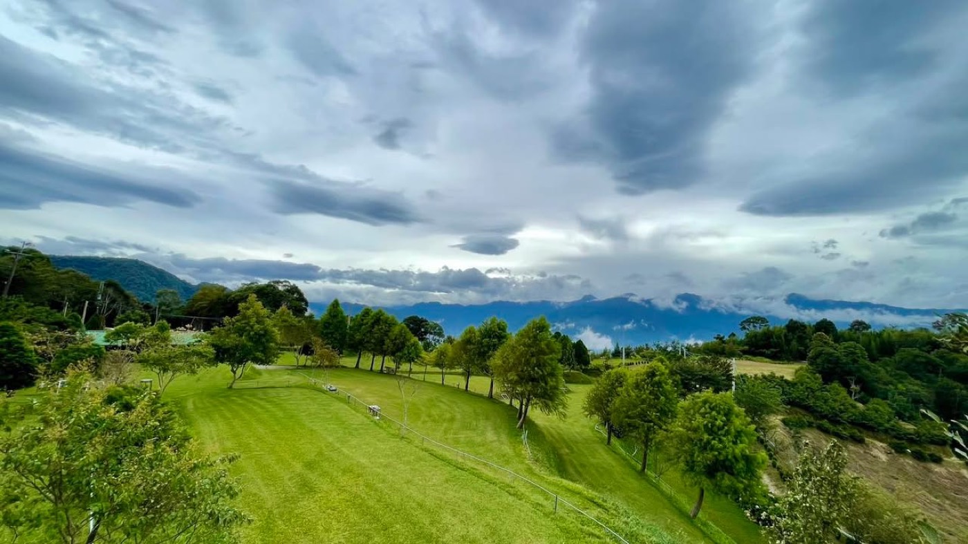 雲霧農場草地留白與山景，呈現低密度露營距離